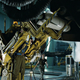A Colonial Marine uses a Power Work Loader to load an AGM-204A Threat Suppression Attack Missile onto a UD-4 dropship, 2179.